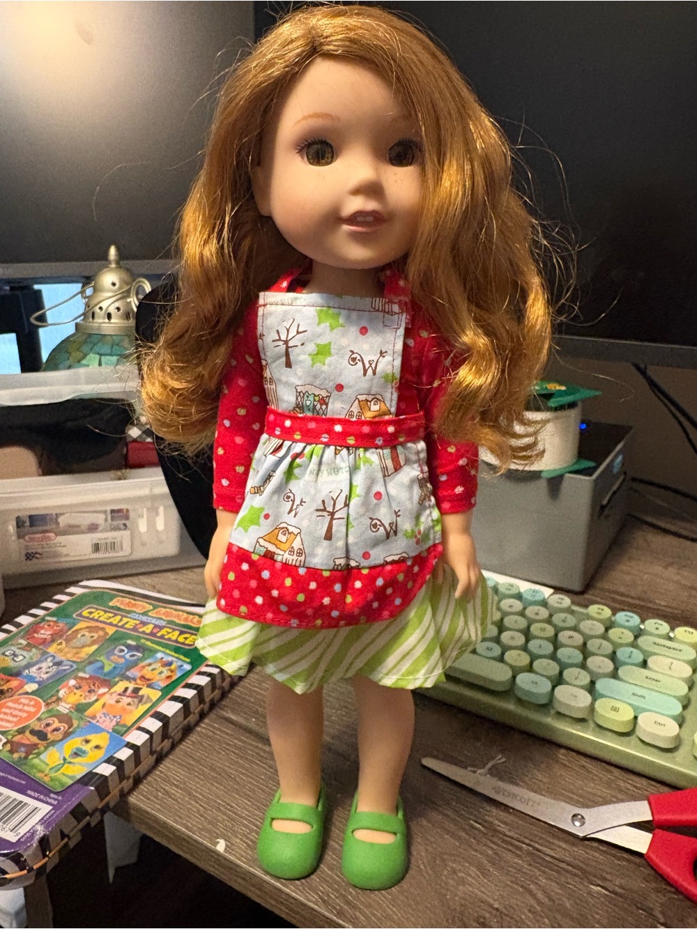 American Girl Wellie wisher doll with red green dress and lime shoes.